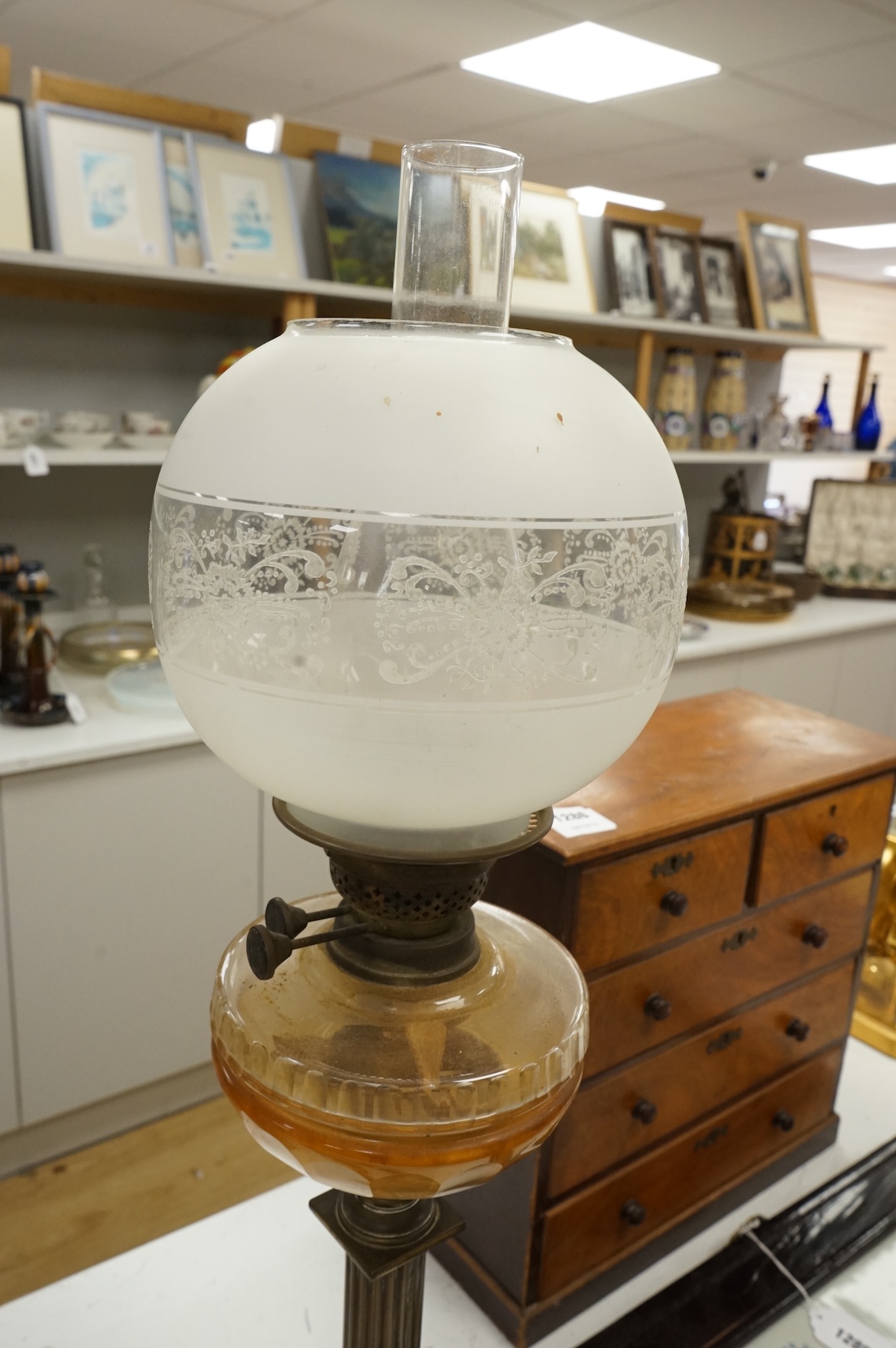 A brass oil lamp with columnar base and etched glass shade, 72cm high overall